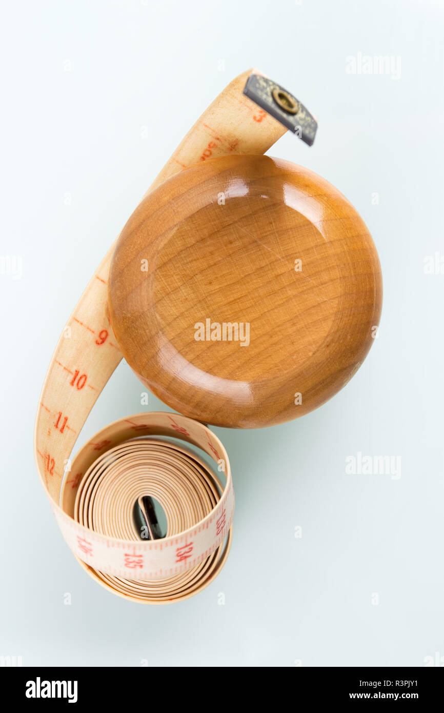 Yoyo effect in diet concept. Wooden yoyo with centimeter measure