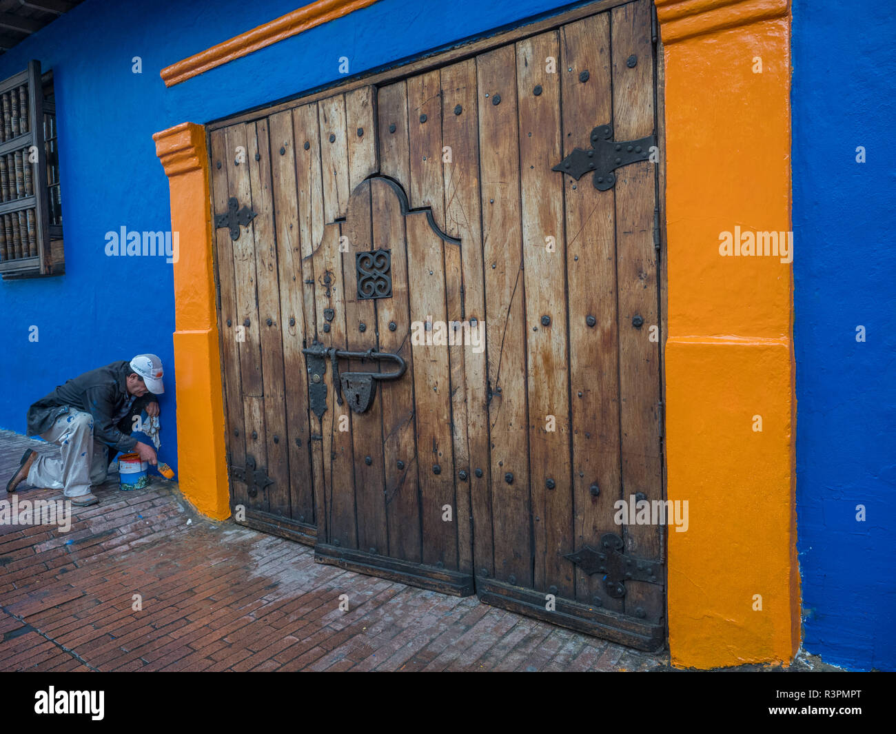 Bogota, Colombia - September 13, 2013: Colombian man is painting the wall on the street of Bogota Stock Photo