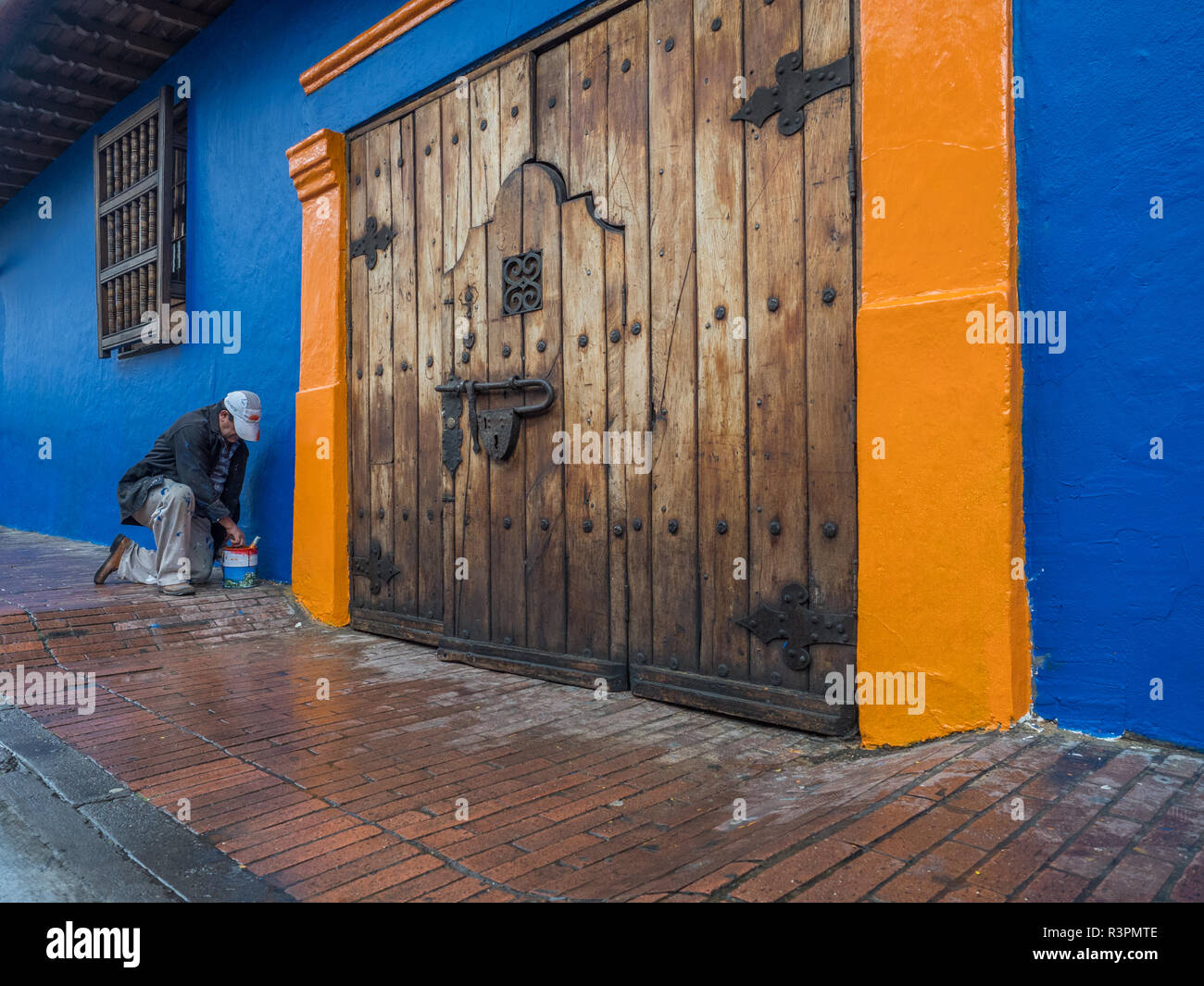 Bogota, Colombia - September 13, 2013: Colombian man is painting the wall on the street of Bogota Stock Photo