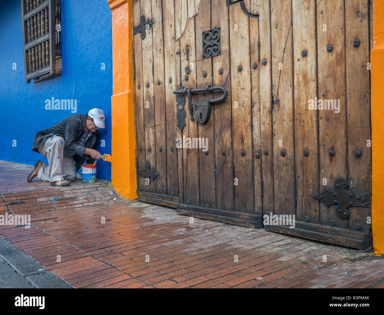 Bogota, Colombia - September 13, 2013: Colombian man is painting the wall on the street of Bogota Stock Photo