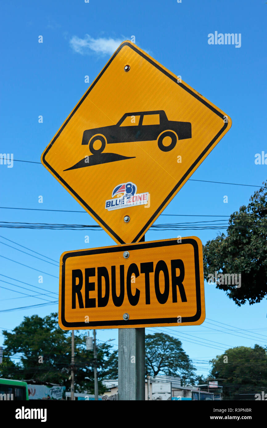 Reductor road sign in Costa Rica - speed bump or speed bumps Stock Photo