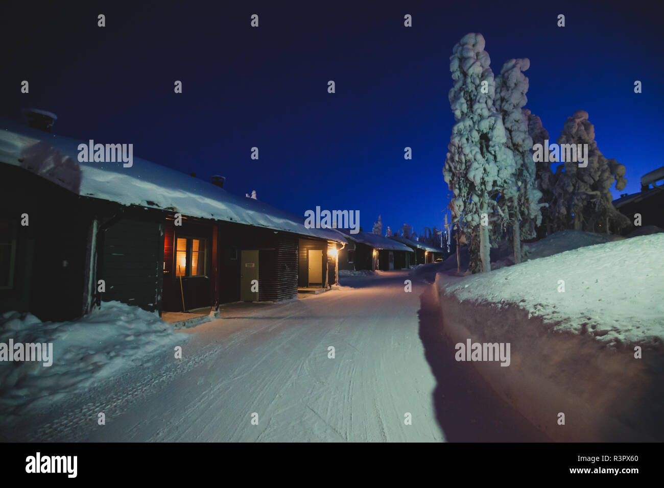 A cozy wooden cabin cottage chalet house covered in snow near ski ...