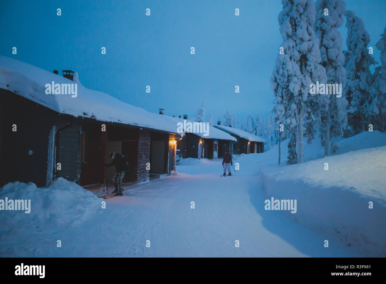A cozy wooden cabin cottage chalet house covered in snow near ski ...