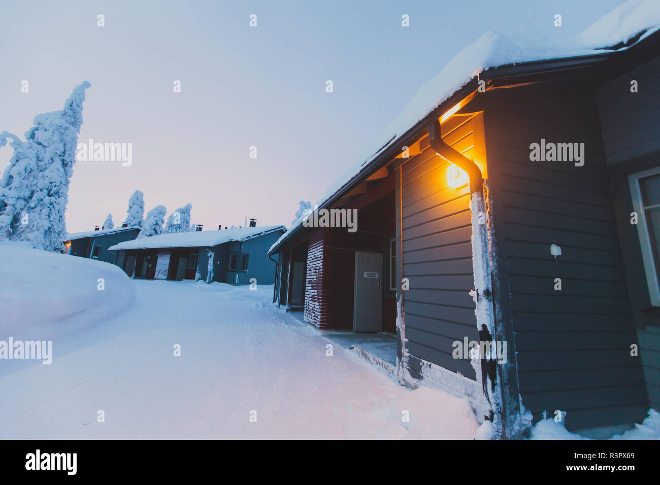 A cozy wooden cabin cottage chalet house covered in snow near ski ...