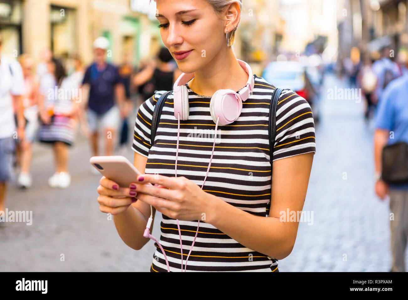 Woman using smartphone on the street Stock Photo