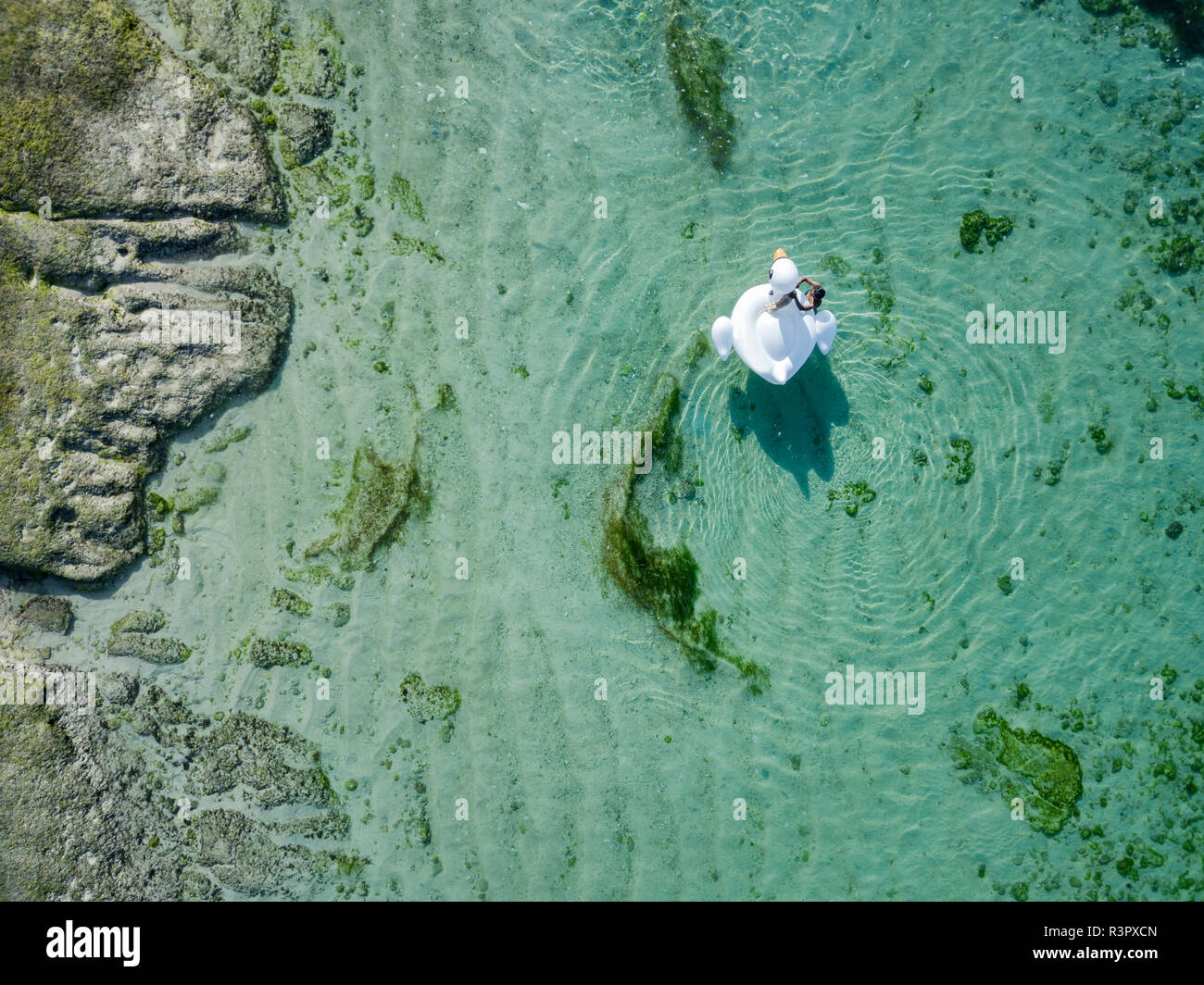 Indonesia, Bali, Aerial view of Karma Kandara beach, one woman, airbed floating on water Stock Photo