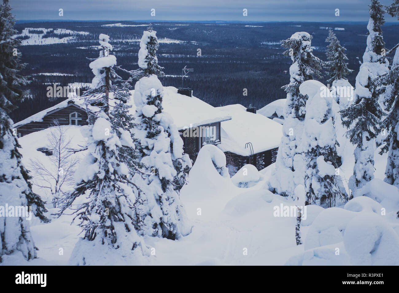 A cozy wooden cabin cottage chalet house covered in snow near ski ...