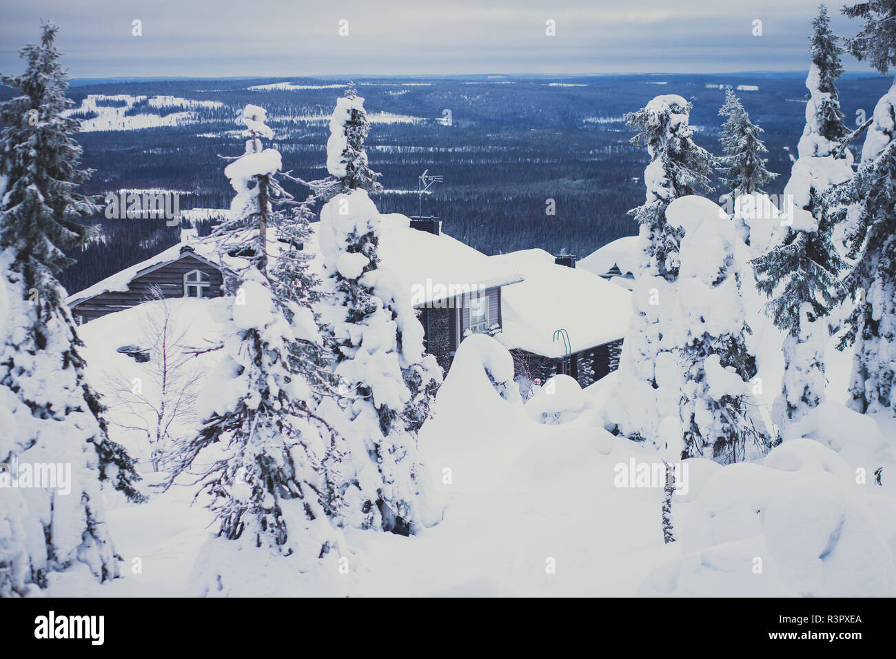 A cozy wooden cabin cottage chalet house covered in snow near ski ...