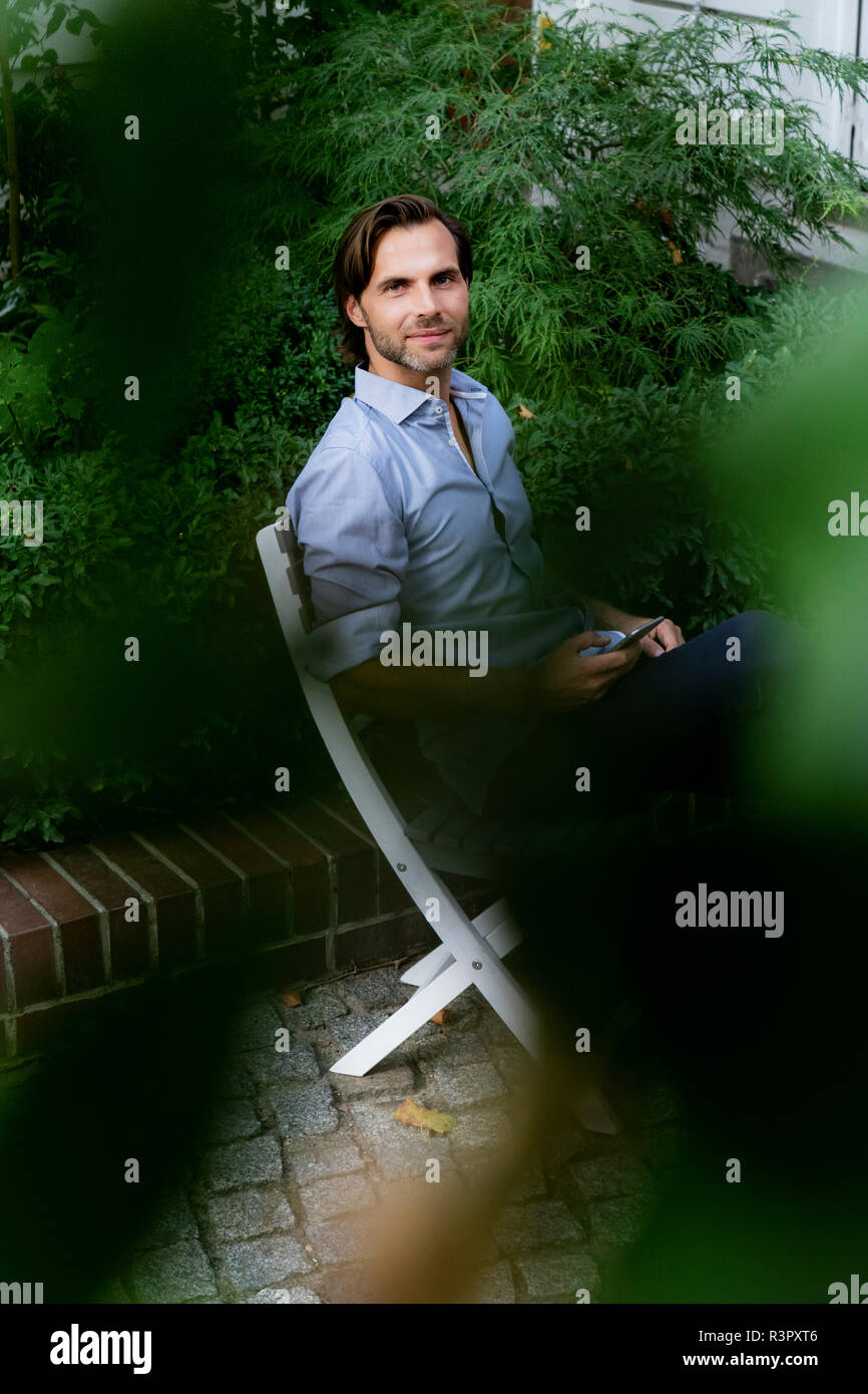 Man sitting chair hi-res stock photography and images - Alamy