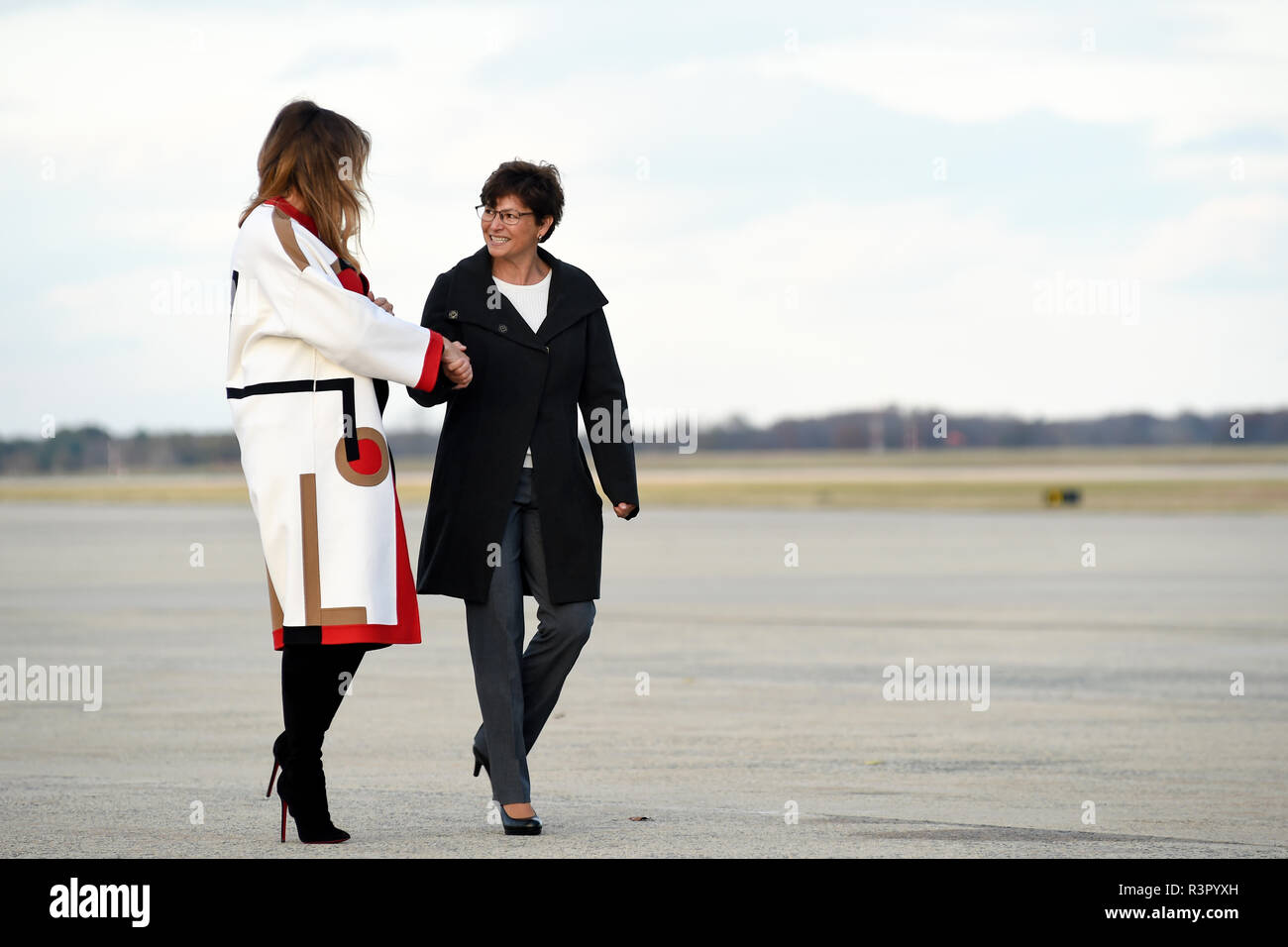 First Lady of the United States Melania Trump, (left) shakes hands with Kathy Helms, wife of Col. Rebecca Sonkiss, 89th Airlift Wing commander as Helms escorts the First Lady to Air Force One, Nov. 20, 2018 Joint Base Andrews, Md. (U.S. Air Force photo/Staff Sgt. Kenny Holston) Stock Photo