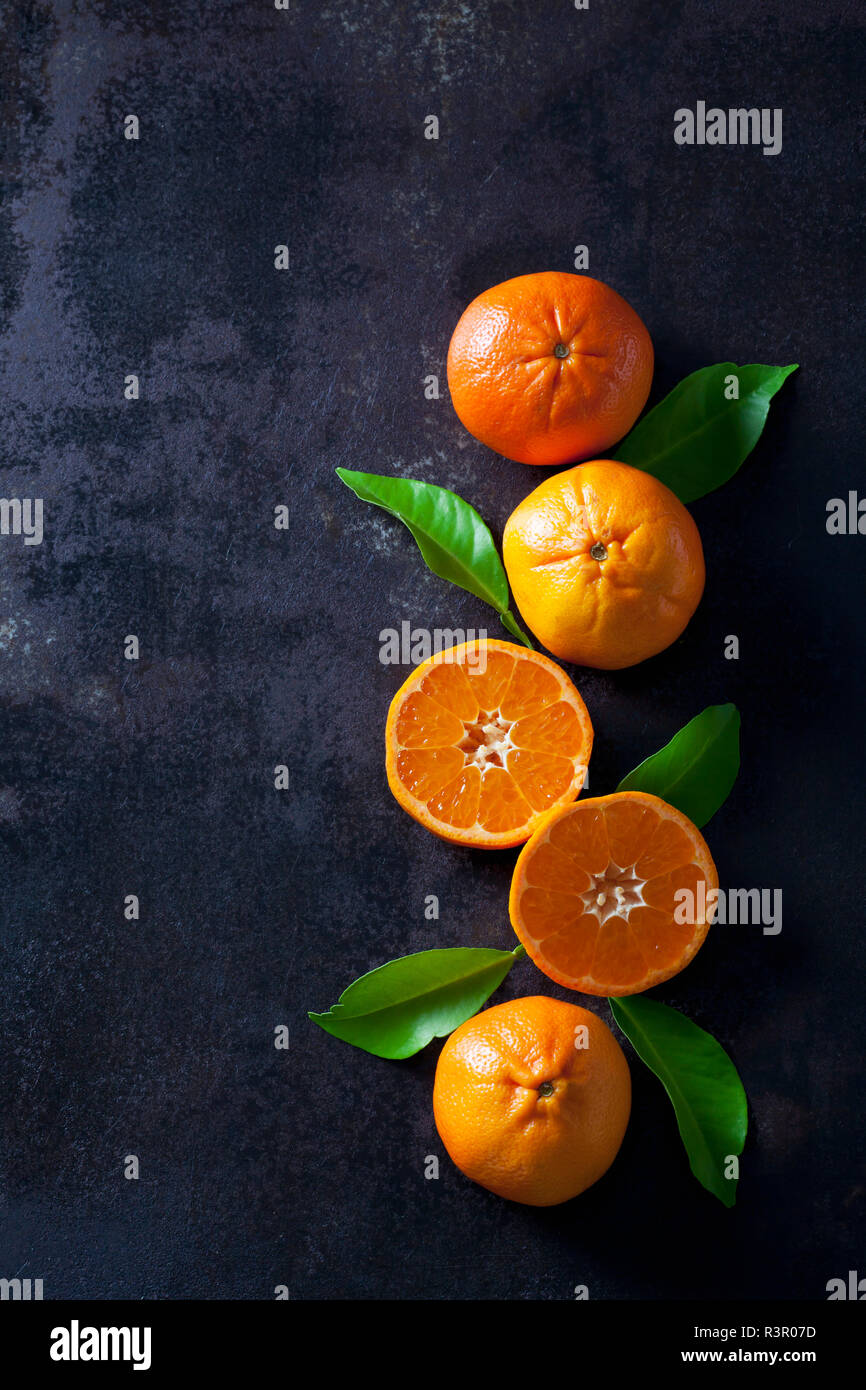 Sliced tangerines on dark backround Stock Photo