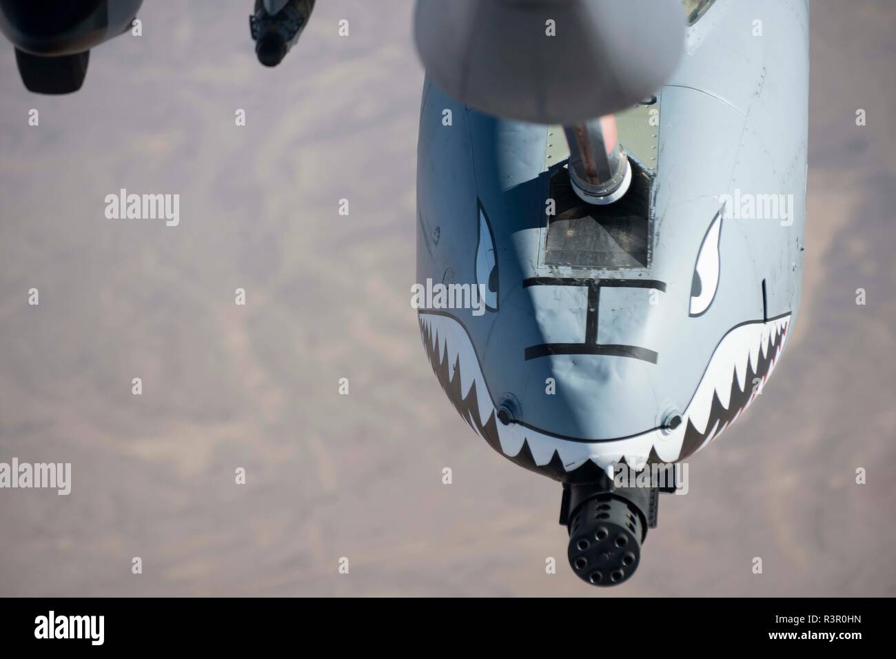 An A-10 Thunderbolt II, assigned to the 75th Expeditionary Fighter Squadron, receives fuel from a KC-135 Stratotanker, assigned to the 340th Expeditionary Air Refueling Squadron, while flying over Kandahar Province, Afghanistan, Nov. 18, 2018. The air refueling aircraft enables to warfighters to stay in their mission longer and keep persistent presence overhead. (U.S. Air Force photo by Senior Airman Kaylee Dubois) Stock Photo