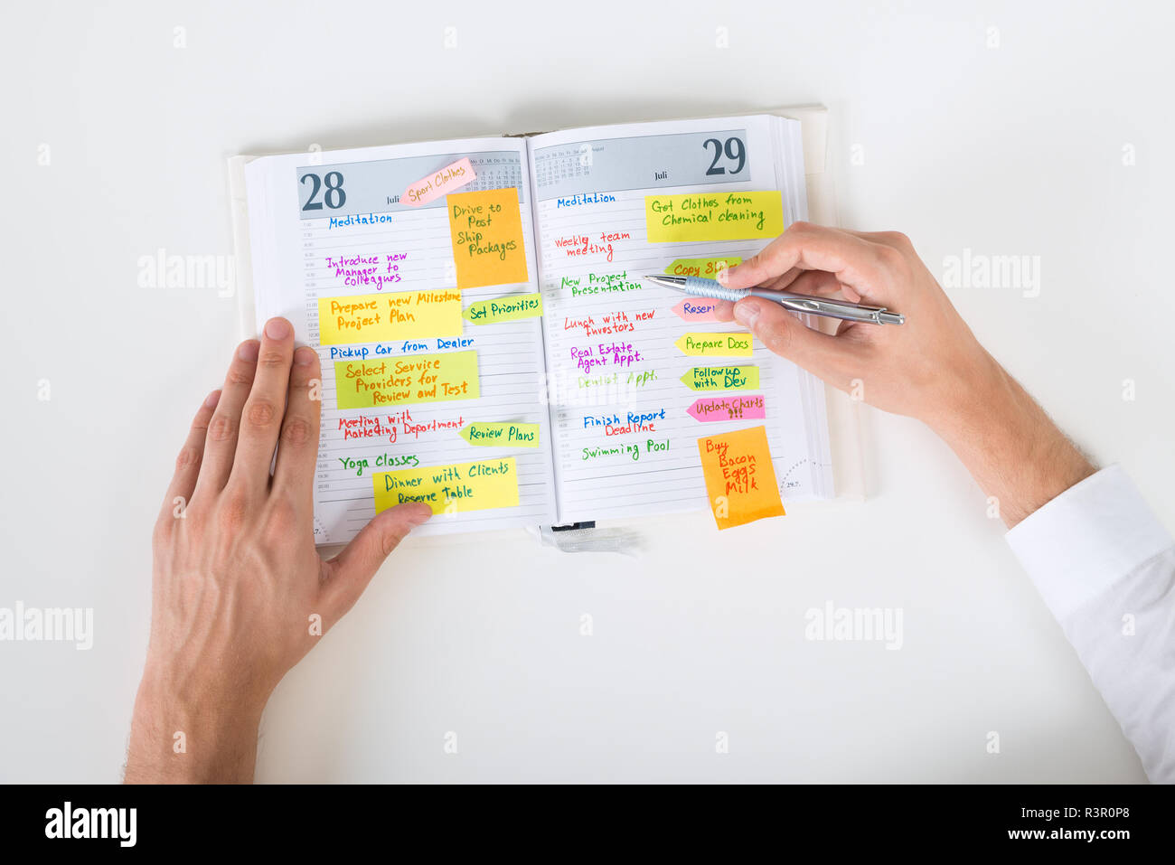 Businessperson Writing Note In Diary Stock Photo - Alamy