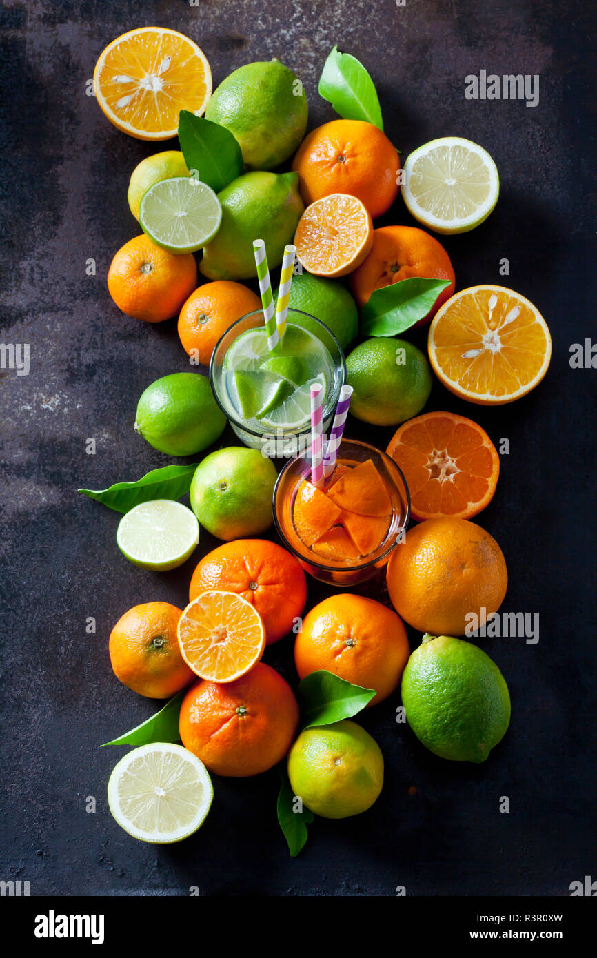 Limes, lemons, oranges and tangerines om dark background Stock Photo