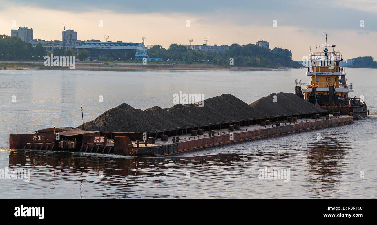 Coal is transported by barge on the Rybinsk Reservoir in Russia. Part of the Volga-Baltic waterway. Stock Photo
