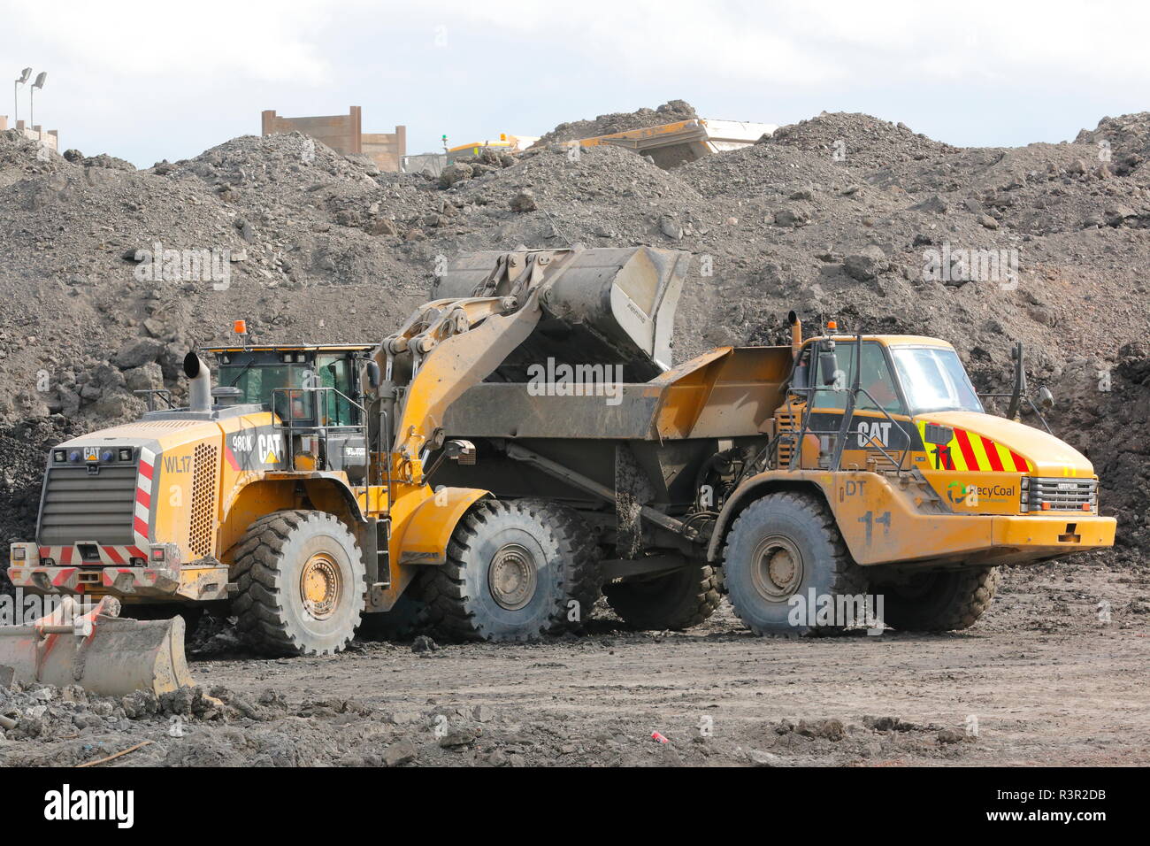 A Caterpillar 980H loading a Caterpillar 740D ADT on the Recycoal Coal Recycling Plant in Rossington,Doncaster which has now been demolished. Stock Photo