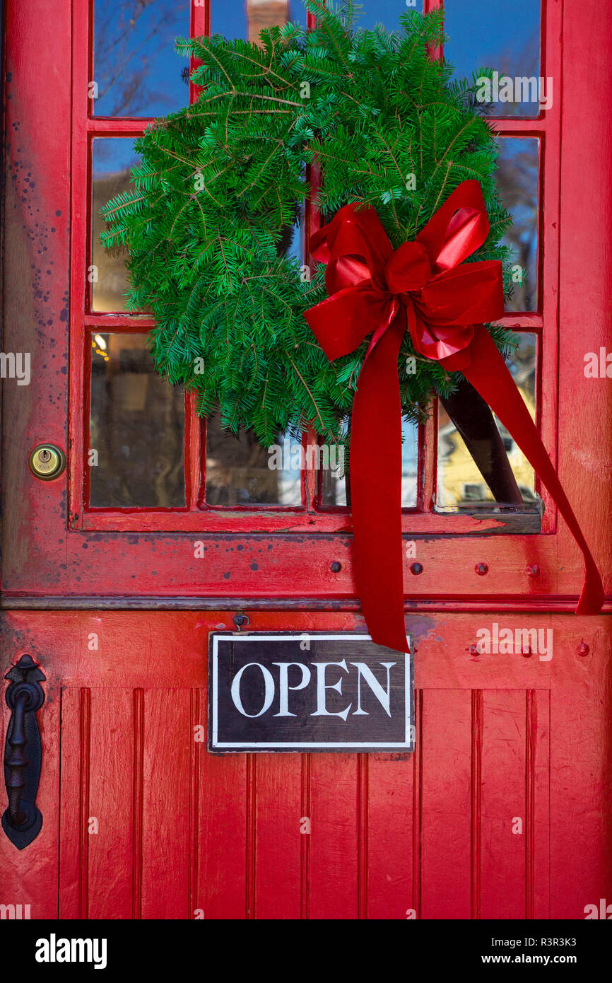 Red Store Entrance Door With Open Sign And Christmas Wreath Stock
