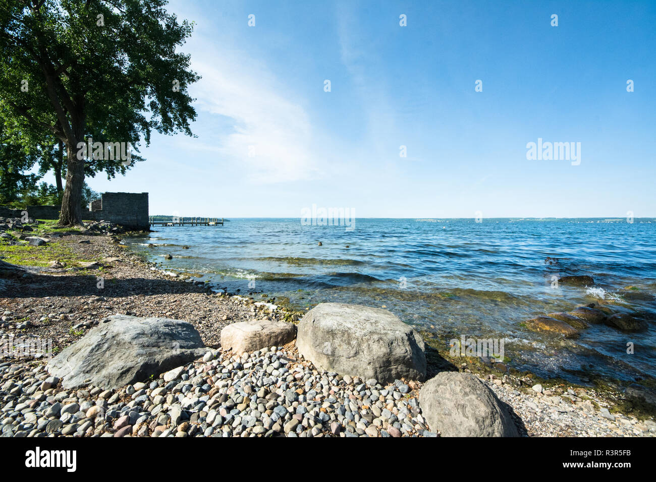 A rocky shore along Cayuga Lake, in the New York Finger Lakes in Aurora, NY Stock Photo