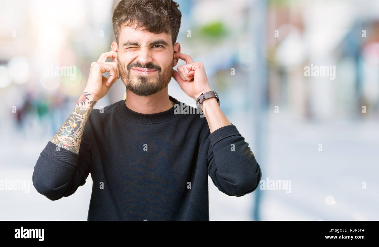 Young Handsome Man Over Isolated Background Covering Ears With Fingers With Annoyed Expression 