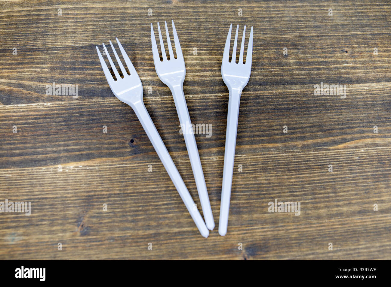 white plastic forks on a wooden dark background Stock Photo Alamy