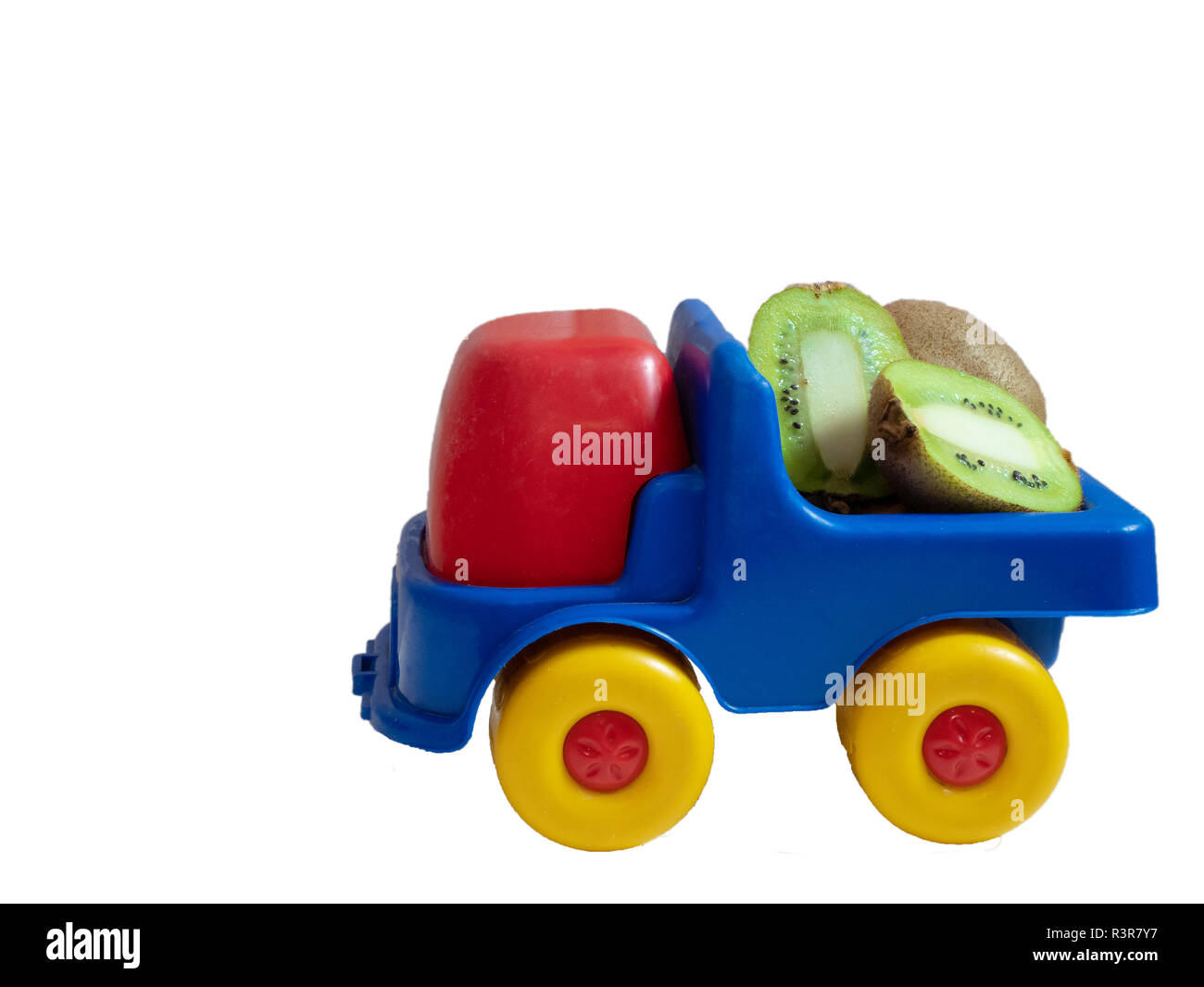 small toy car truck with kiwi fruits. exotic fruit delivery. side shot