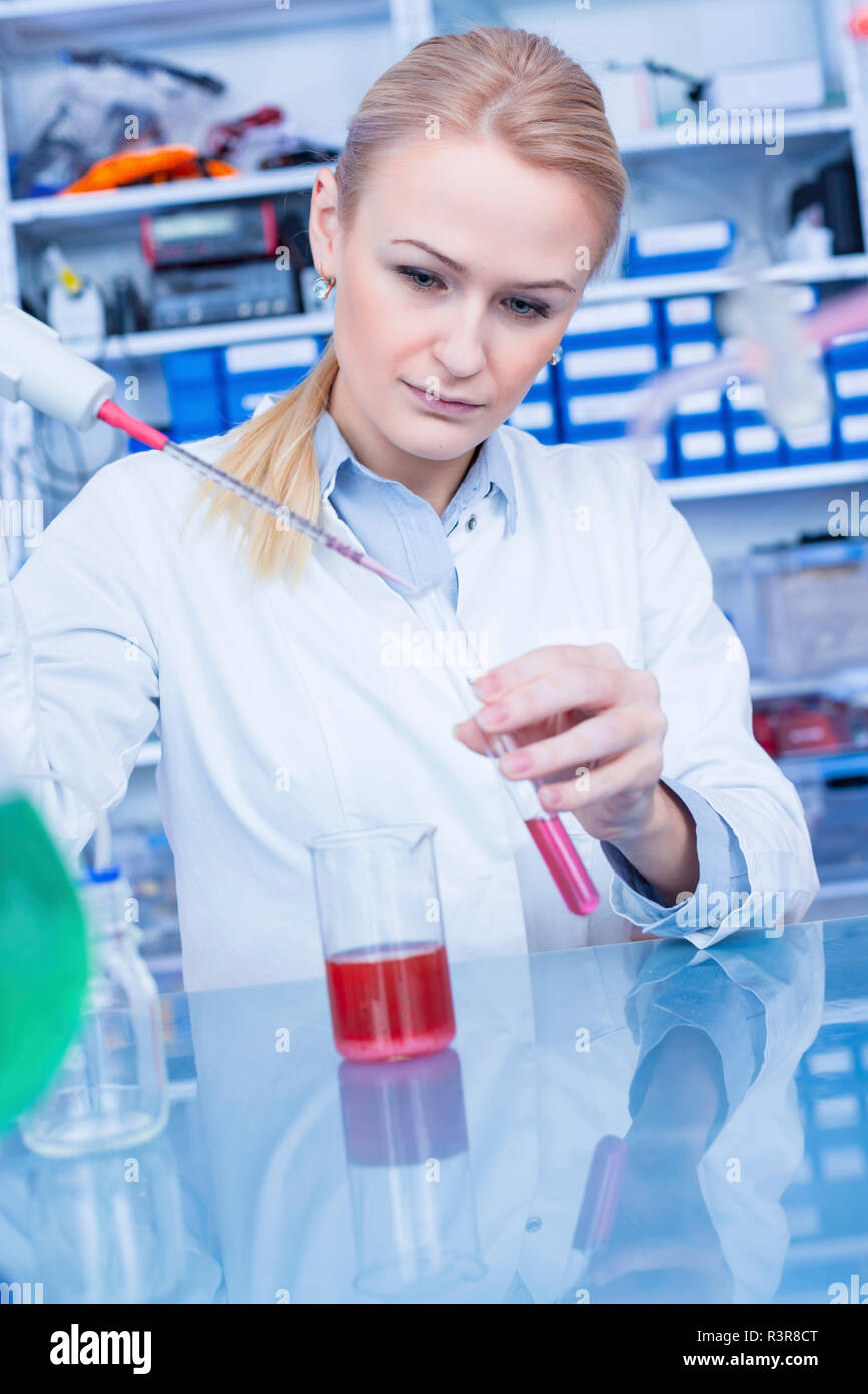 Laboratory assistant pipetting liquid into test tube Stock Photo Alamy