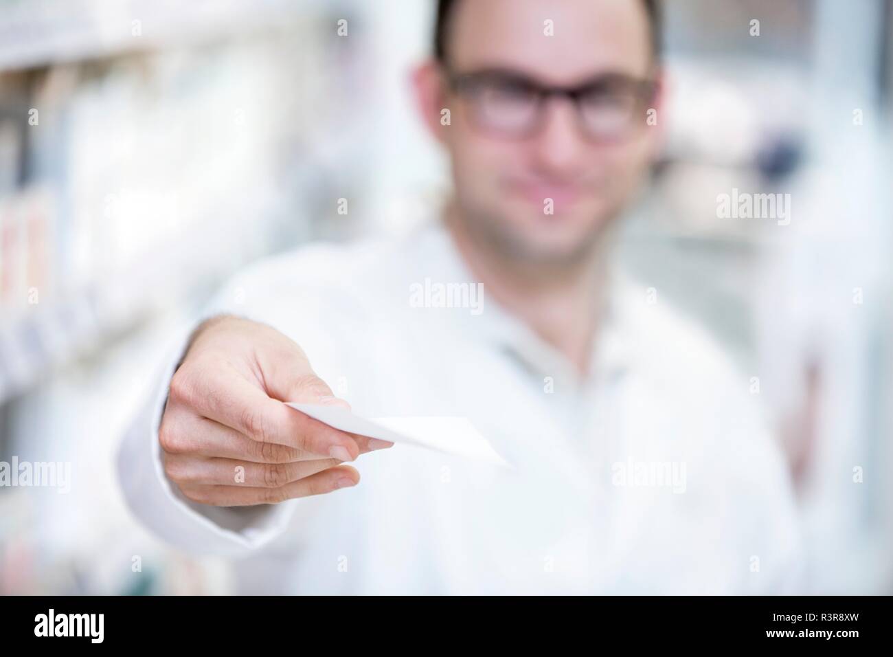 Pharmacist showing prescription in pharmacy. Stock Photo