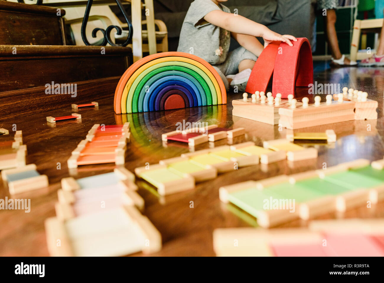 Children playing with wooden rainbow waldorf montessori Stock Photo - Alamy