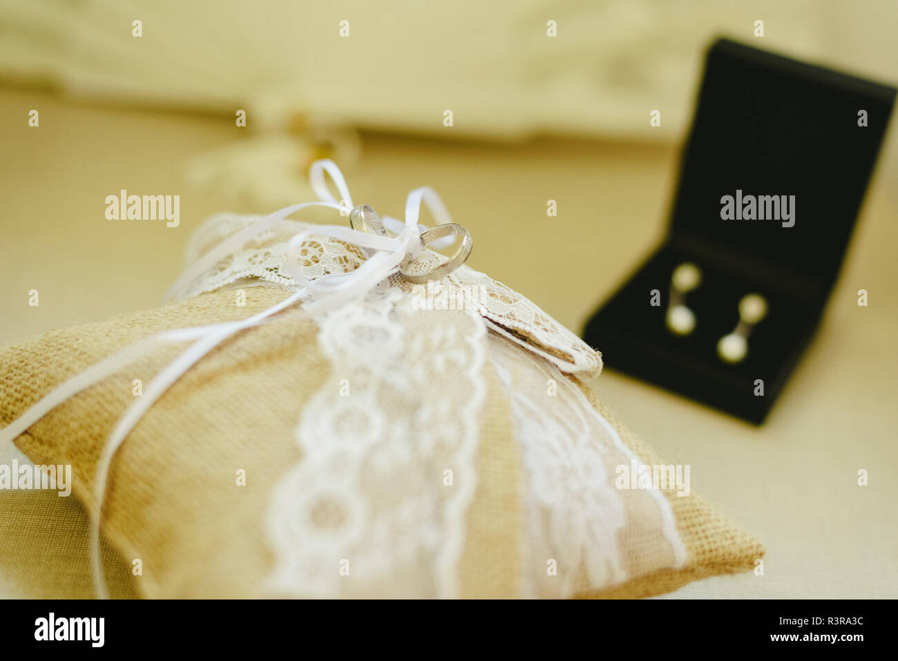 Wedding rings in a glass Stock Photo - Alamy