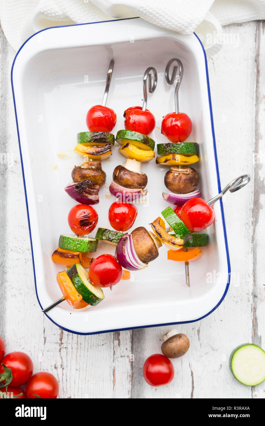 Vegetarian grill spits, orange and yellow paprika, tomato, red onion