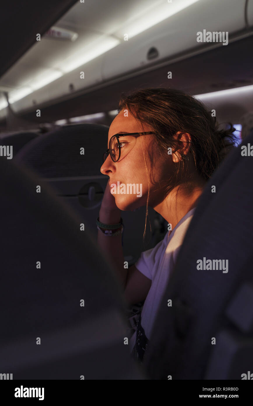 Young woman in a plane in sunshine Stock Photo