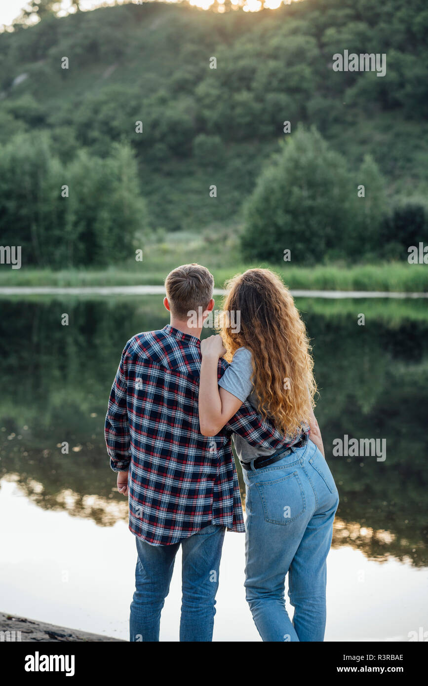 Romantic couple standing riverside hi-res stock photography and images ...