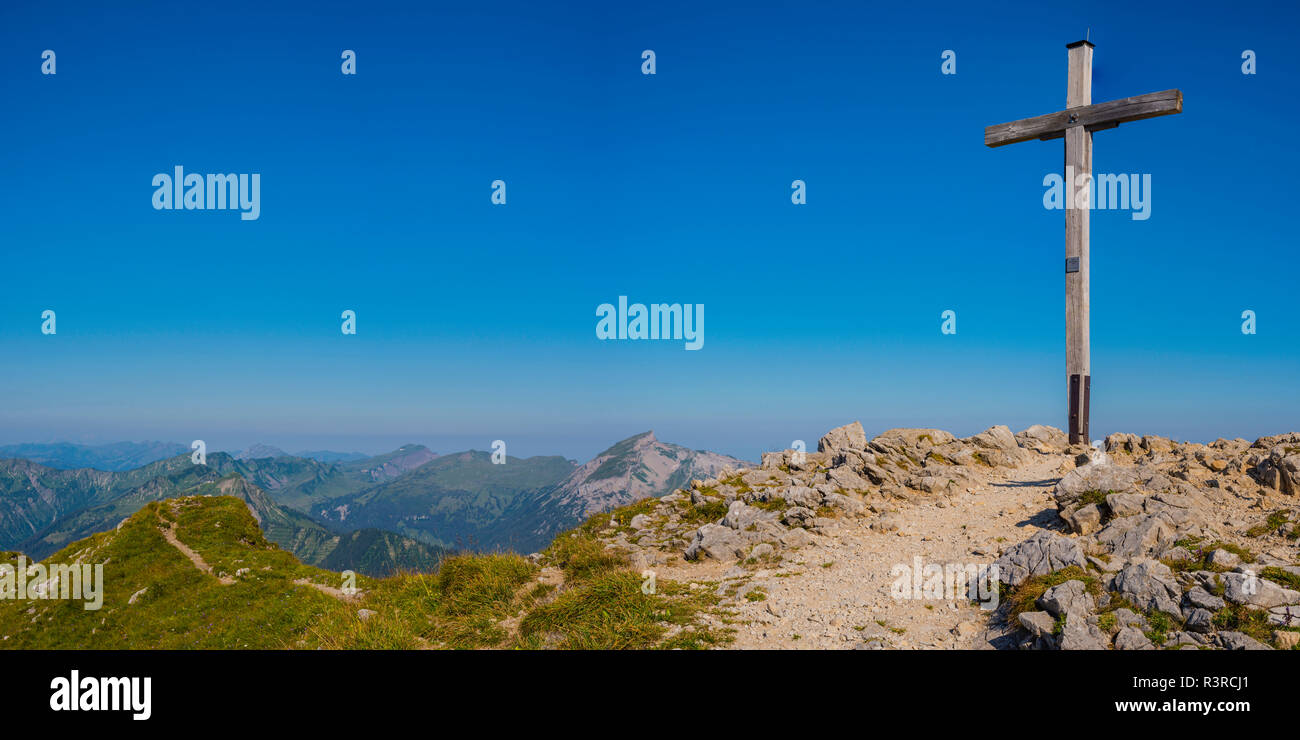Austria, Walser Hammerspitze summit cross looking over the Allgaeu Alps in Bavaria, Germany Stock Photo