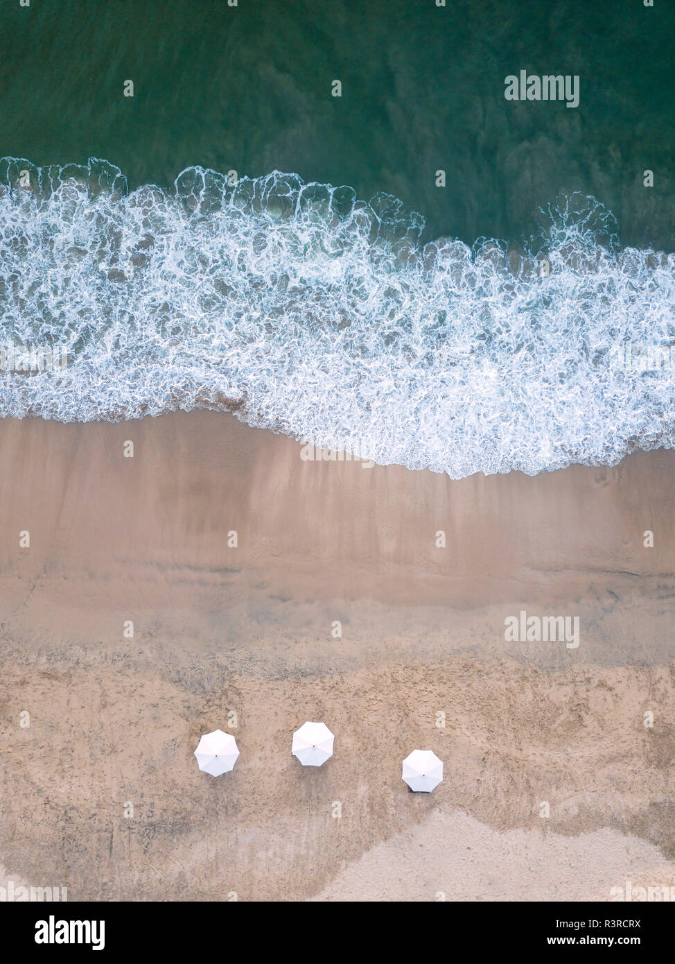 Indonesia, Bali, Aerial view of Jimbaran beach, white sunshades from above Stock Photo