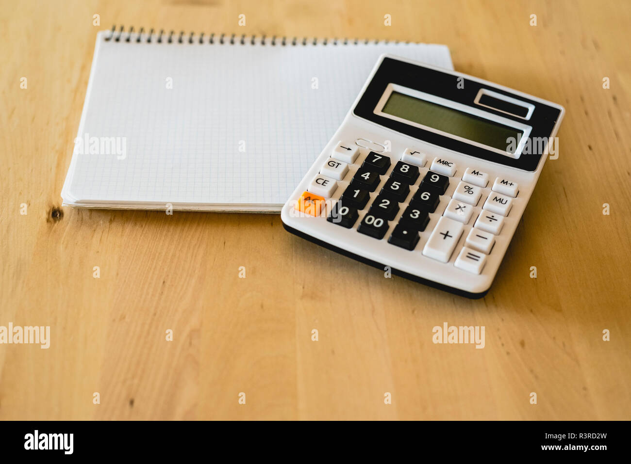 Calculator and pad to calculate business expenses Stock Photo Alamy