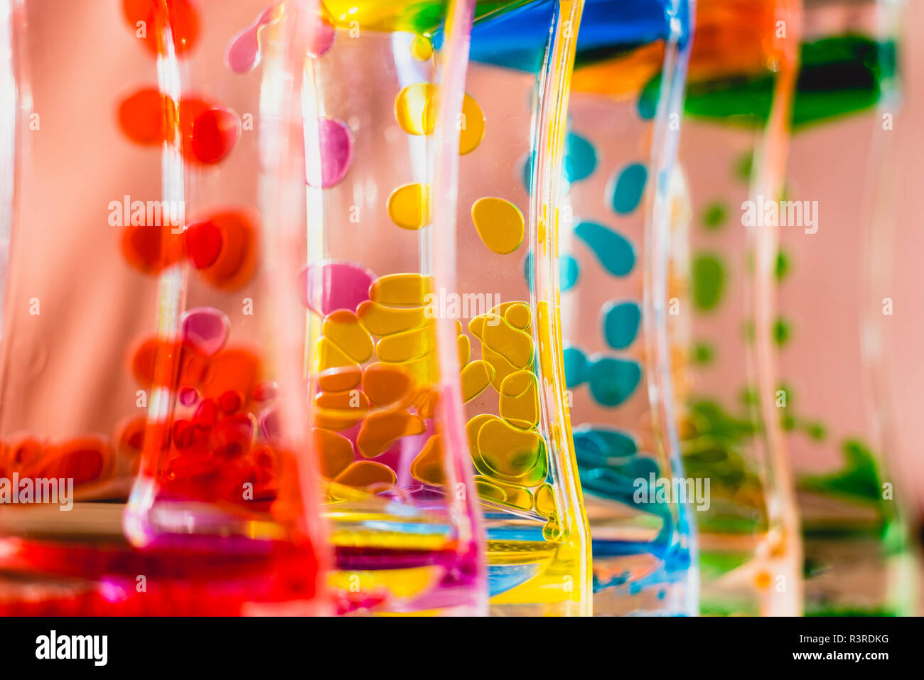 Toy with water and drops of oil colors Stock Photo - Alamy