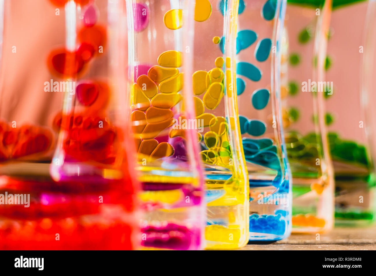 Toy with water and drops of oil colors Stock Photo - Alamy