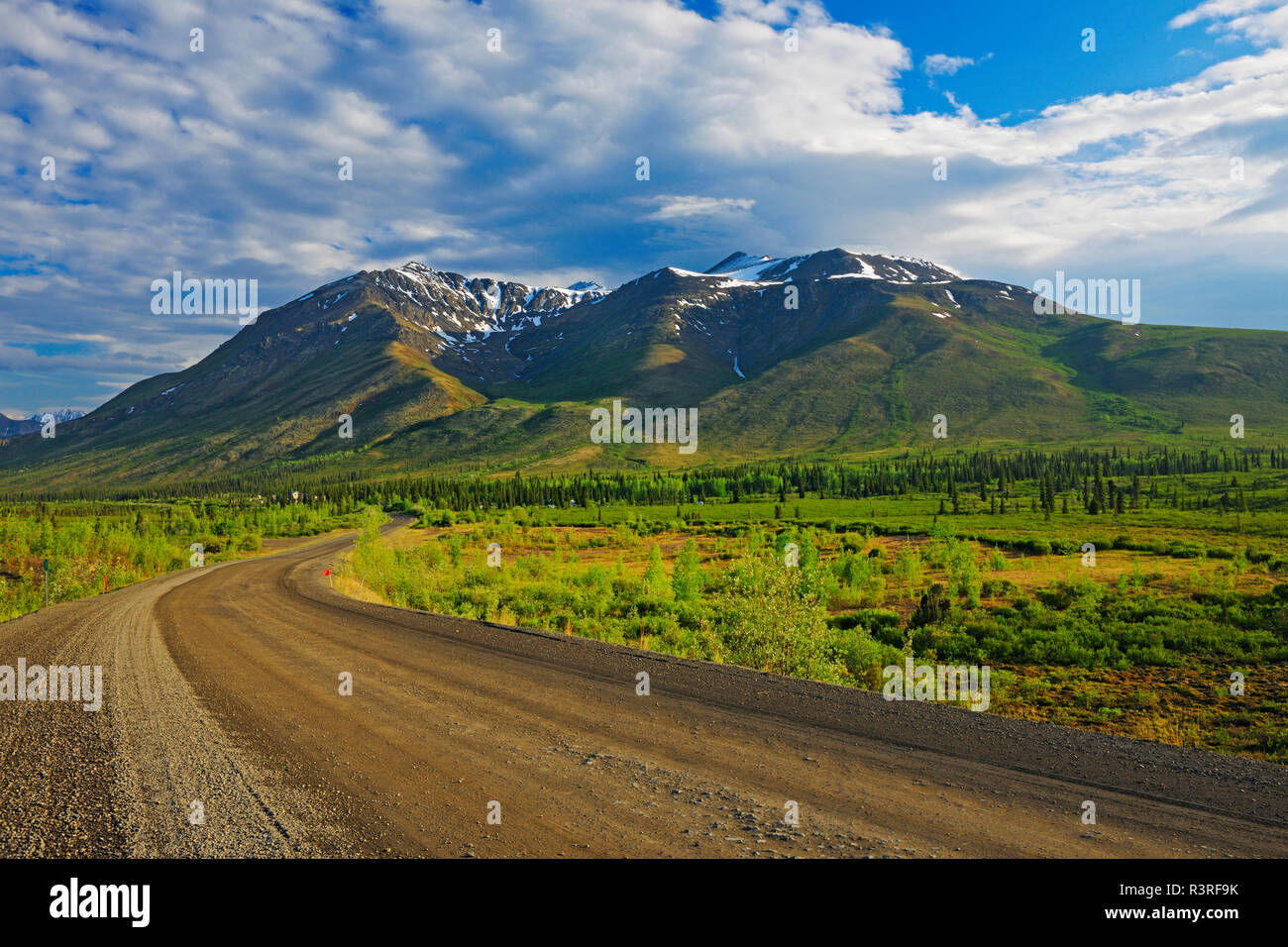 Ogilvie Mountains. Dirt road and mountains. Stock Photo