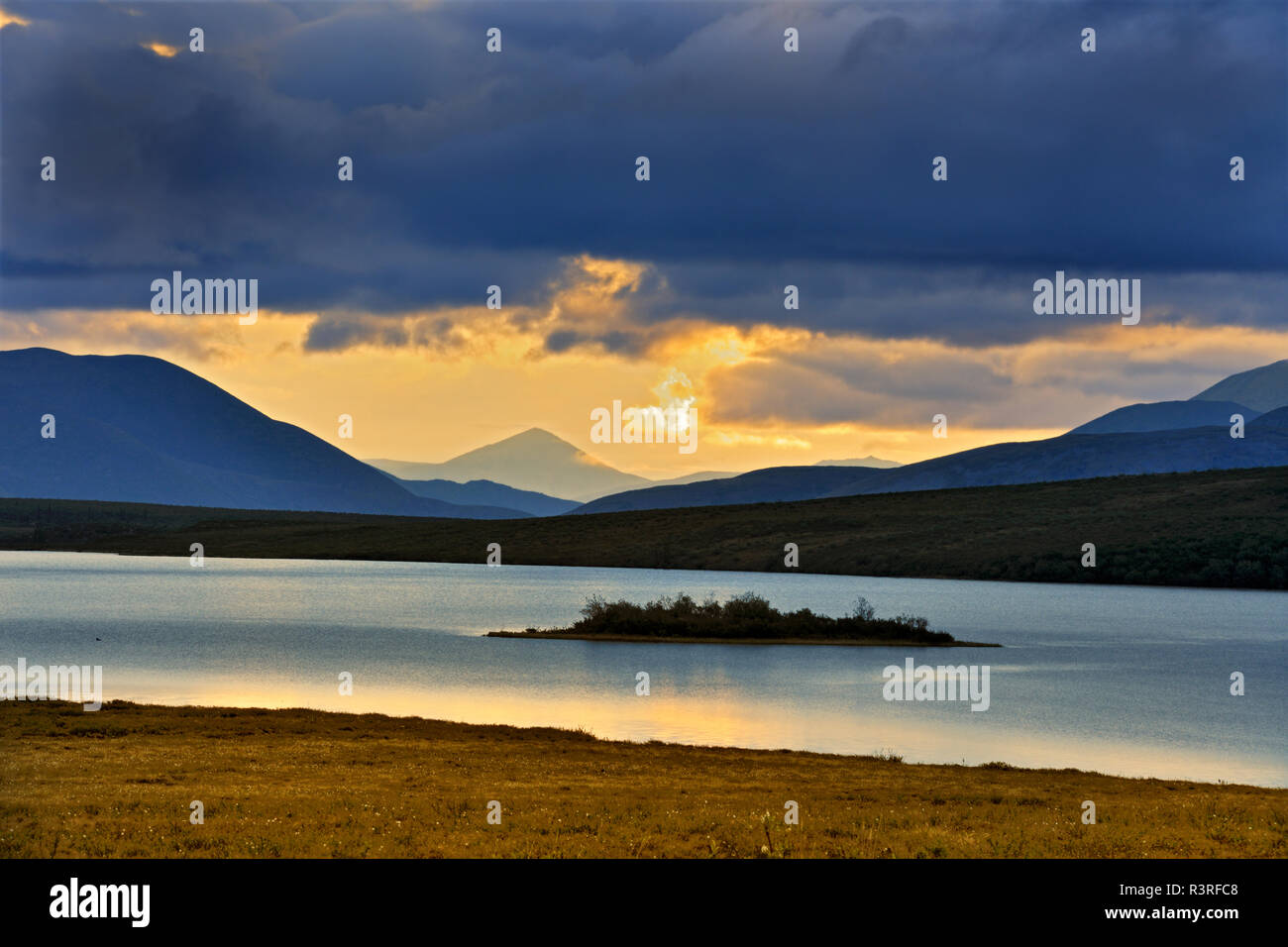 Ogilvie Mountains. Mountain and lake landscape sunrise. Stock Photo