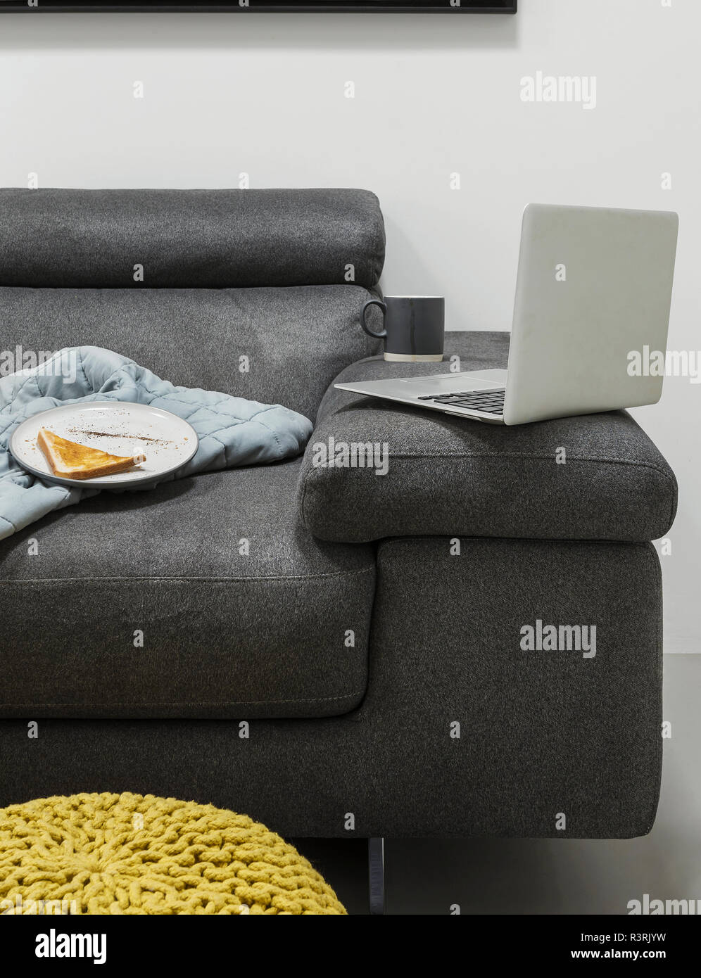 Shot of a laptop on sofa Stock Photo
