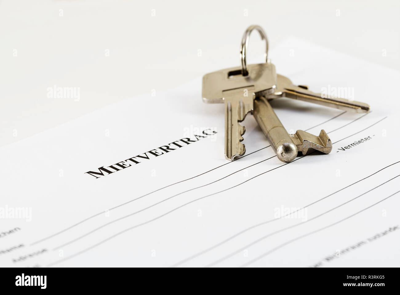 German lease agreement document with house keys,  Mietvertrag means rental contract, copy space, selected focus, narrow depth of field Stock Photo