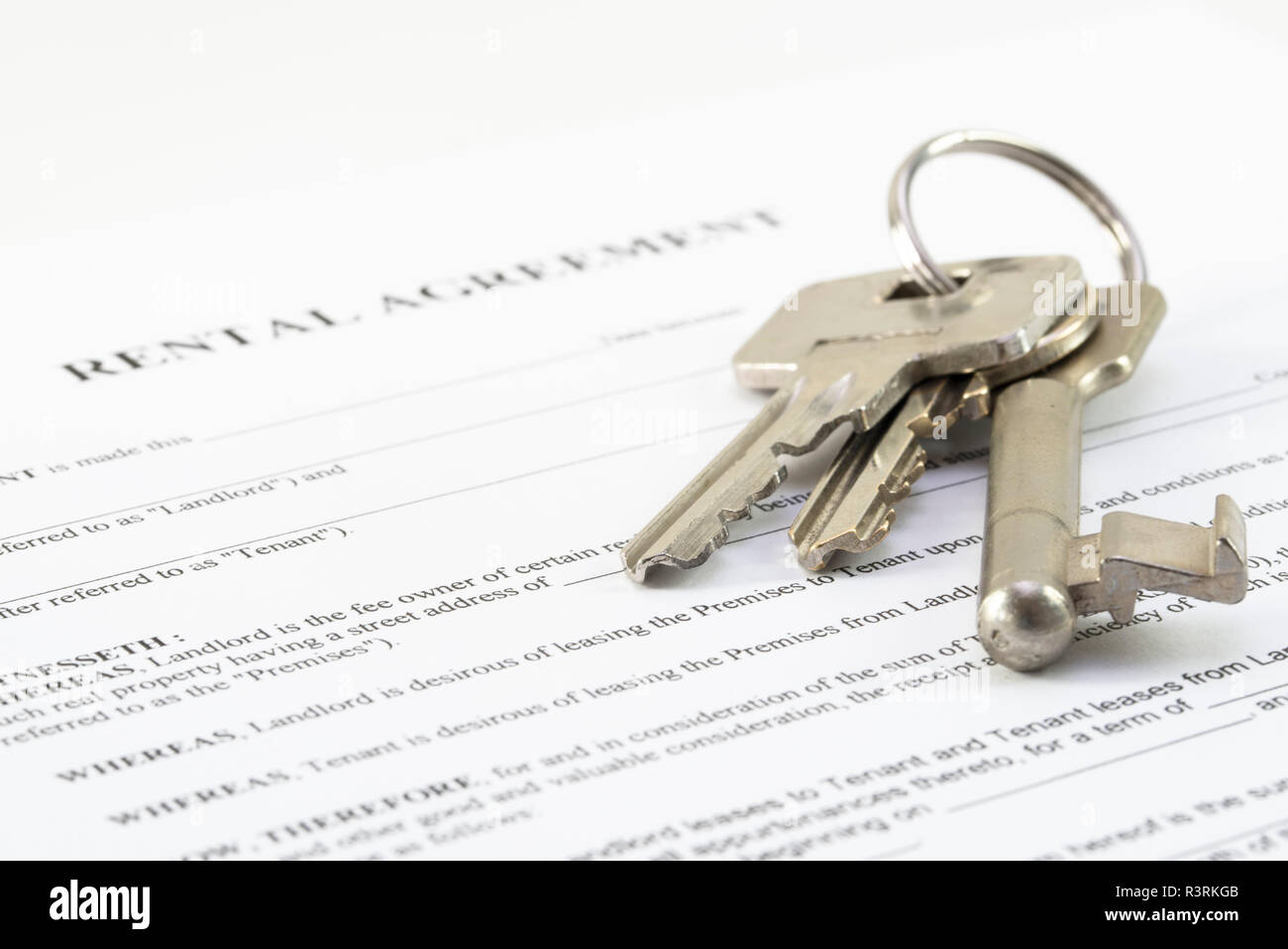 rental agreement document with a set of house keys, selected focus,very  narrow depth of field Stock Photo