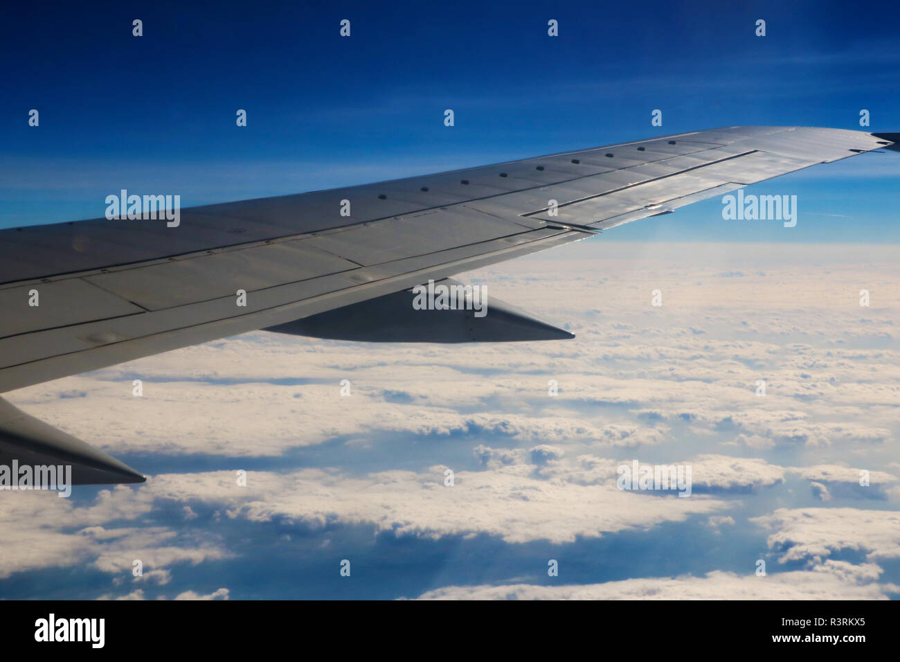 Seeing the plane's wing and the outer view from the window Stock Photo