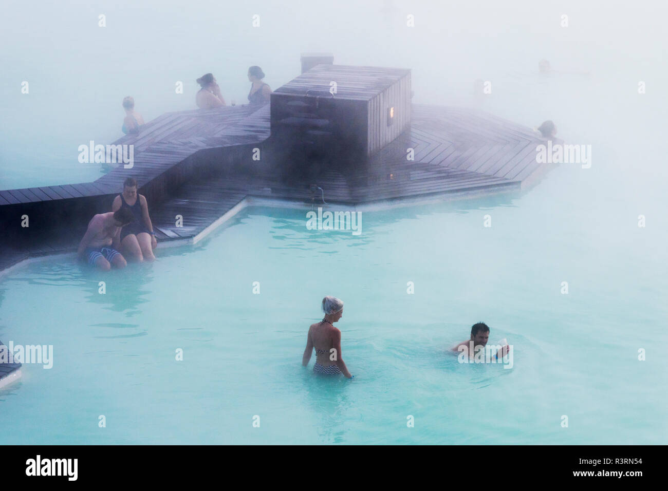 Europe, Iceland, Reykjanes Peninsula, Between Keflavik and Grindavik, Blue Lagoon. People bathing in the waters of the Blue Lagoon Spa. Stock Photo