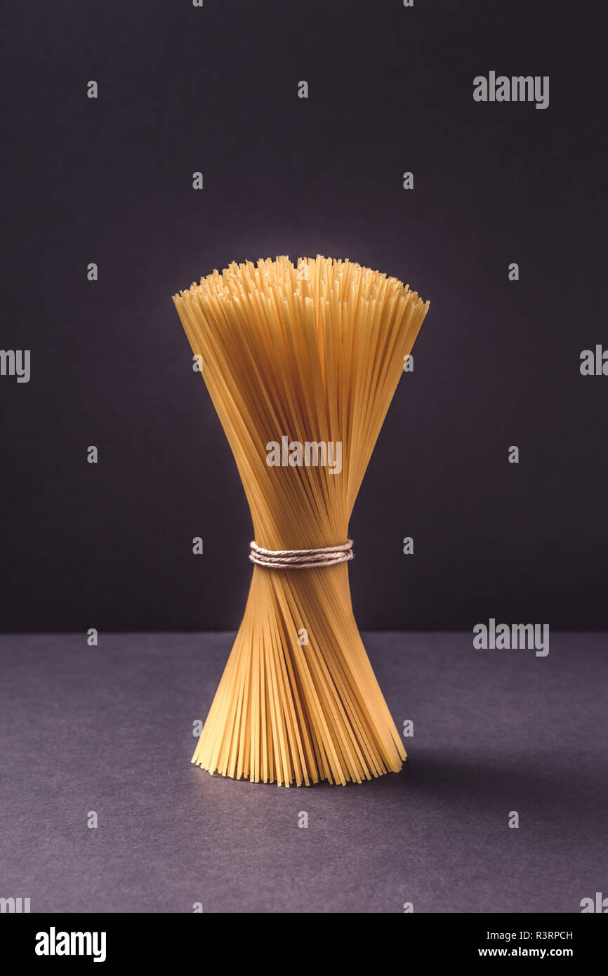spaghetti in bunch on black background Stock Photo