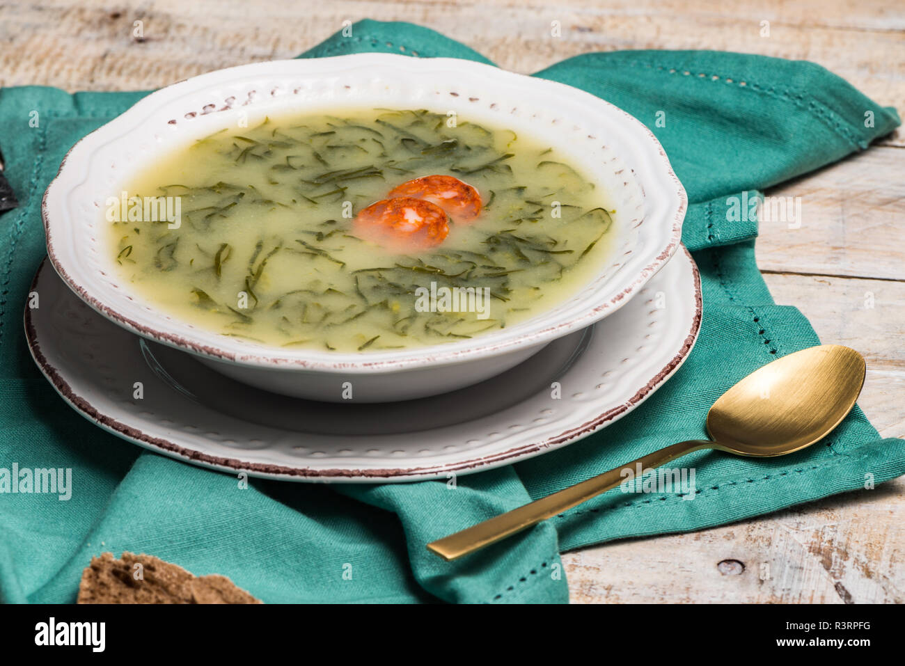 Caldo verde popular soup in Portuguese cuisine. traditional ingredients for caldo verde are potatoes, collard greens , olive oil and salt. Additionall Stock Photo