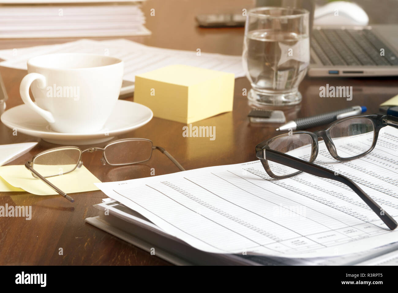 Office Desk With Business Documents Glasses Laptop And Coffee