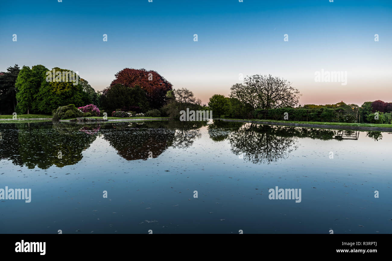 Colorful tree reflections in a water pond on the Royal Domain in Laeken, Brussels, Belgium Stock Photo