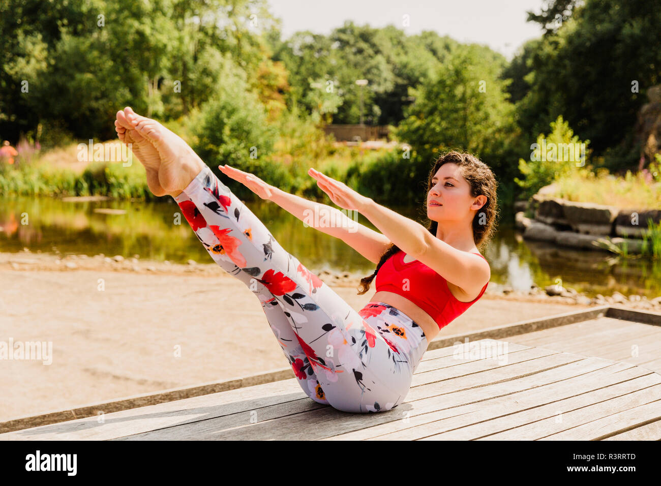 Young woman practicing Pilates in an urban park Stock Photo