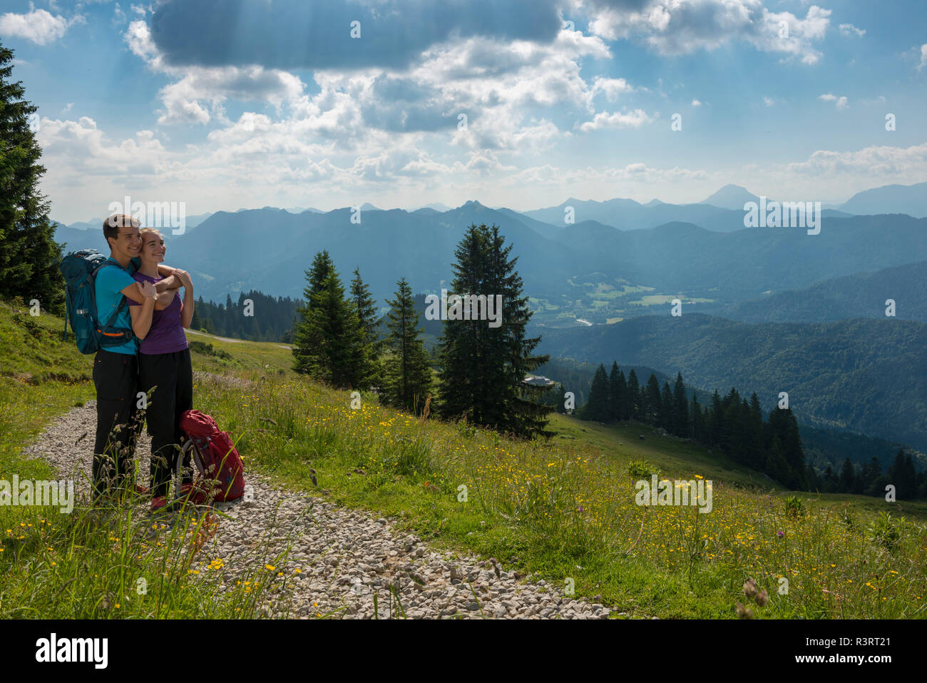 Germany, Bavaria, Brauneck near Lenggries, happy young couple having a break looking at view in alpine landscape Stock Photo